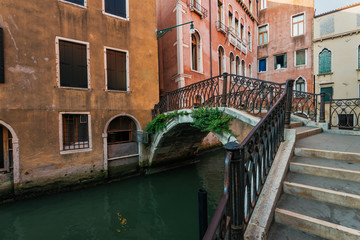 Fototapeta na wymiar Narrow canal among old houses, Venice, Italy.