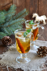 Whiskey cocktail with cinnamon on Christmas background 