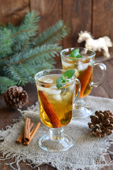 Whiskey cocktail with cinnamon on Christmas background 