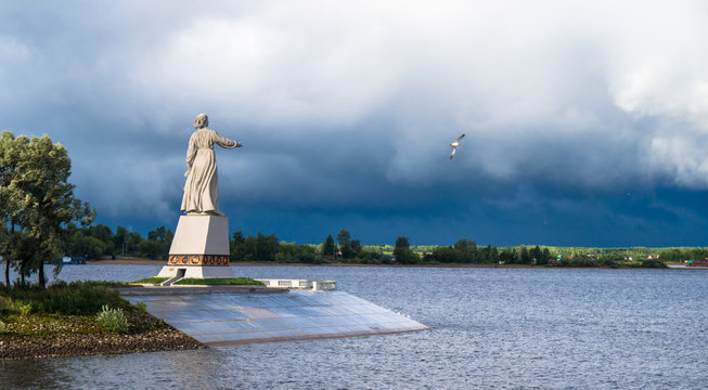 The statue Mother Volga stands with out stretched hand towards the huge reservoir on the approach to the locks at the Rybinsk dam