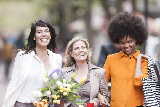 Portrait of three happy women side by side on shopping tour