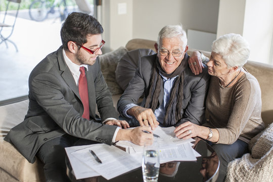 Senior couple at home having a meeting with salesman