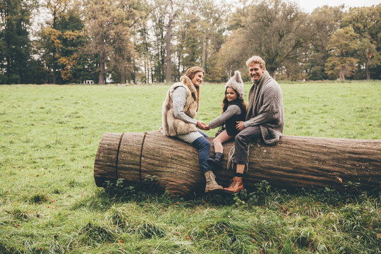Happy family spending time together in an autumnal park