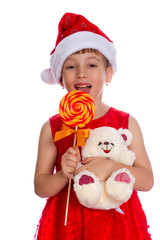 happy girl in santa hat with Christmas candy cane