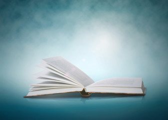 Open book on a blue abstract background