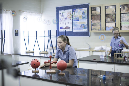 Two schoolgirls in science class