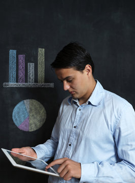 Businessman with tablet checking finacials, male with tablet on