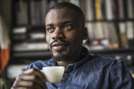 Portrait of young man with cup of coffee