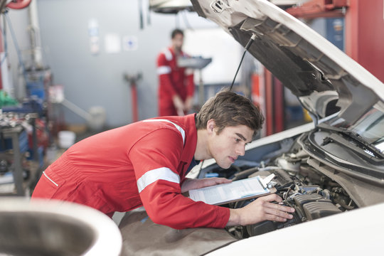 Car mechanic at work in repair garage