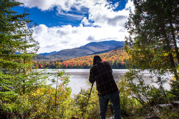 Fototapeta premium Man taking a photograph of the fall color in the Adirondacks 