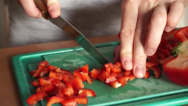 Female hands cutting raw pepper vegetable 4K