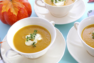 Thanksgiving table setting with pumpkin soup.