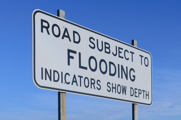 Road subject to flooding warning sign