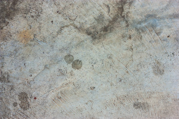 Cement floors are old and dirty.