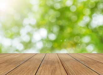Nature bright spring background with sunlight bokeh and perspective wooden plank