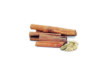 Cinnamon sticks and cardamom isolated on white background
