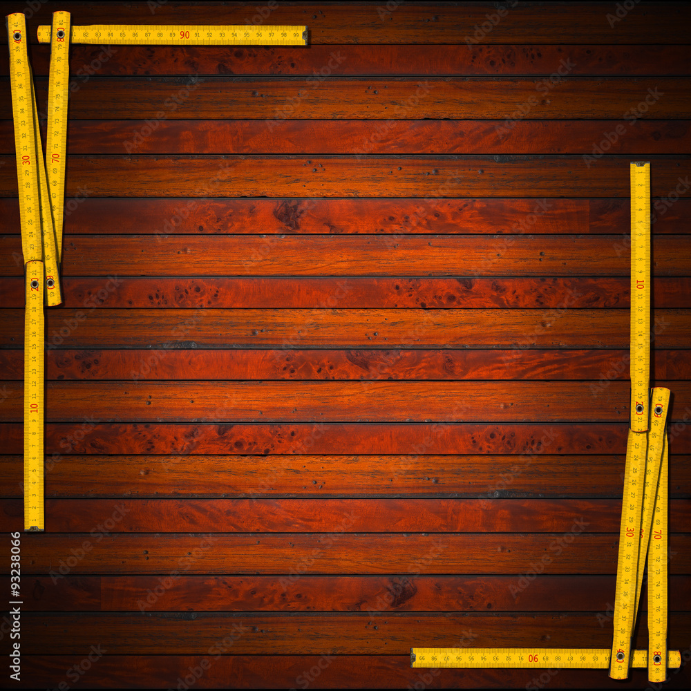 Poster wooden background with ruler frame / frame made from a old wooden ruler on a dark wooden background 