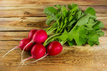 A bunch of radishes on a wooden background. Selective focus.