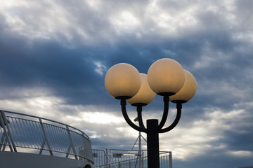burning lamps against the storm sky