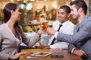 Group of business people  in restaurant toasting business succes