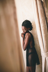 Fototapeta premium Young black woman in the room