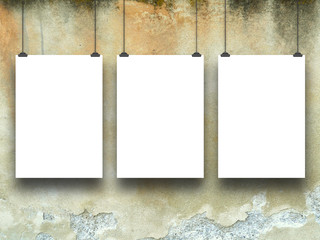 Three empty frames on grungy wall background