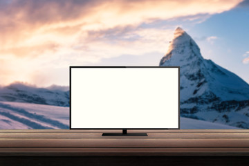 isolated tv on wooden desk with mountain nature background for mock up presentation