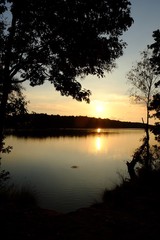 Obraz premium sunset over the forest lake