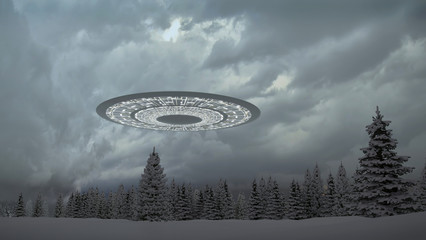UFO in the mountains above the snow-covered forest © kolbass
