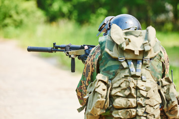 Fototapeta premium Military soldier with pistol
