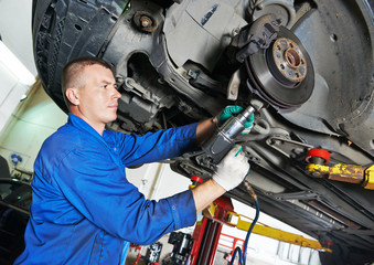 auto mechanic at car suspension repairing