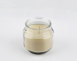 Candle in a glass container on a white background