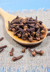 Cloves on a blue board.