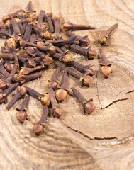 Cloves on a wood board.