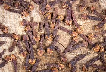 Cloves on a wood board.