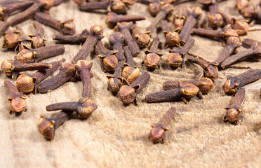 Cloves on a wood board.