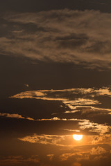 orange sky with sun and black clouds