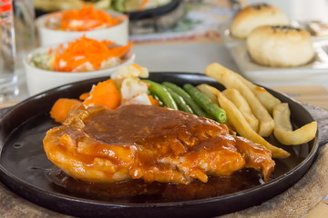 steak and chips on black plate