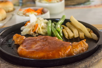 steak and chips on black plate