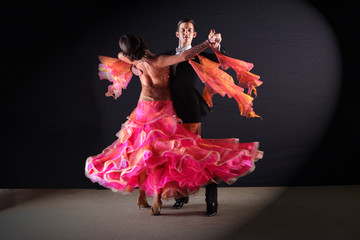 Latino dancers in ballroom isolated on black background