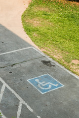 Obraz premium parking space reserved handicapped on road with disabled sign