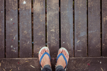 old wooden walkway with falling leaves in the morning of autumn