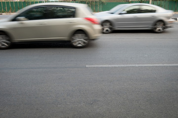 Fototapeta na wymiar car fast motion blurred driving on road