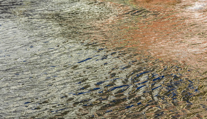 reflection of colorful skyscrapers in the ocean