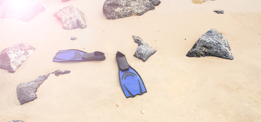 Blue diving fins on  the beach