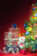 Decorated christmas tree with gift boxes and Santa Clus toy