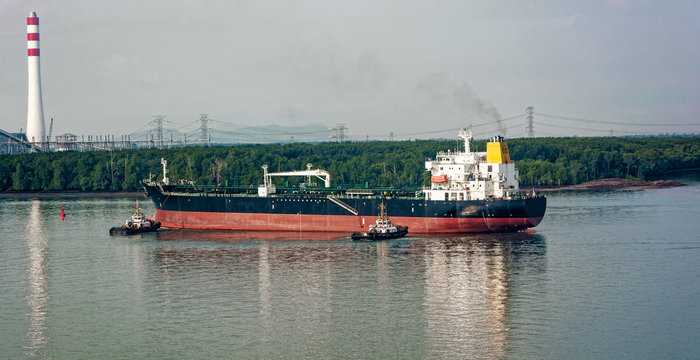 Tugboats assisting oil tanker