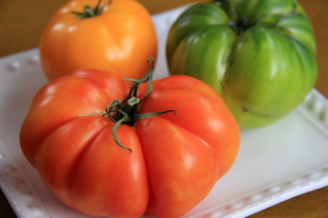 Tempting array of colorful tomatoes on simple white plate