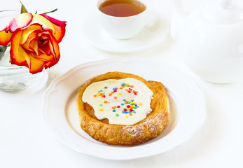 roll with white glaze on a white wooden background