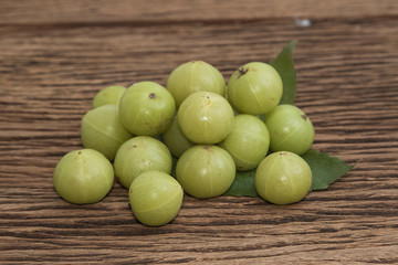 Fresh Indian gooseberry on wooden background